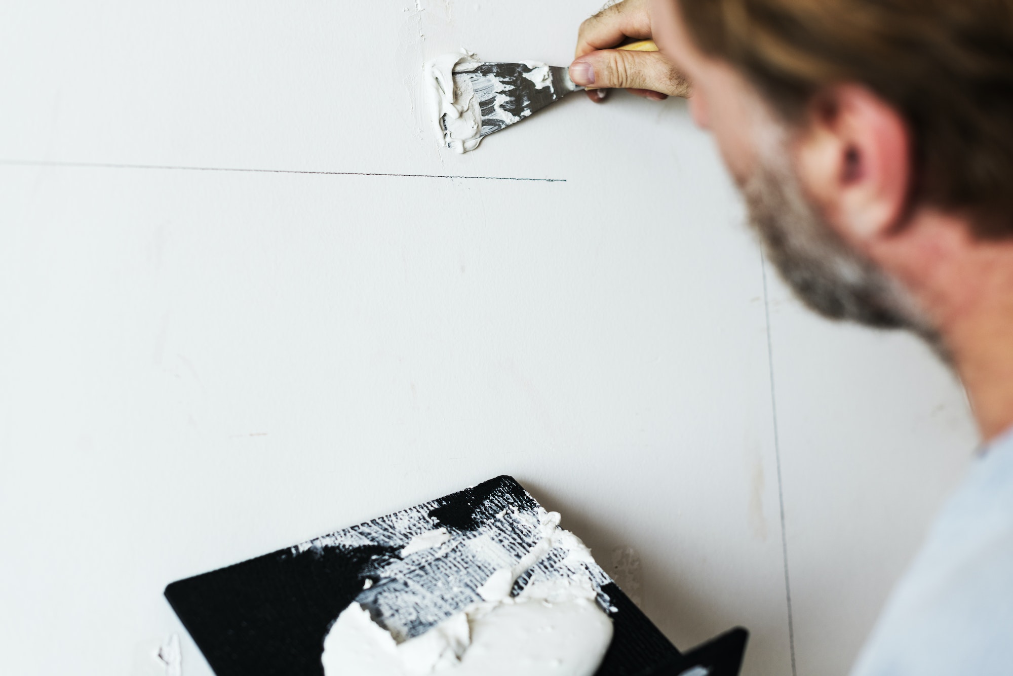 Construction worker painting the wall